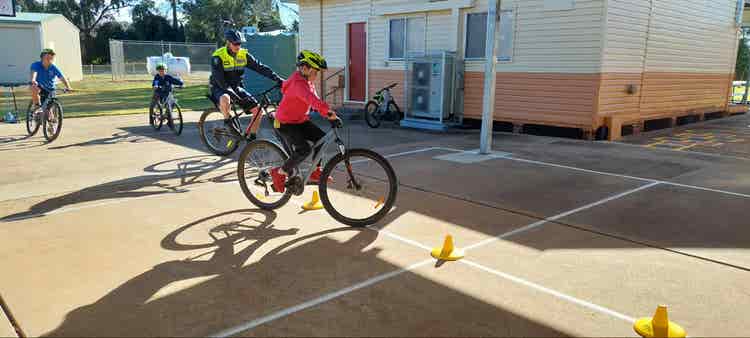 An image of students learning about bike safety as part of our bike/scooter program.